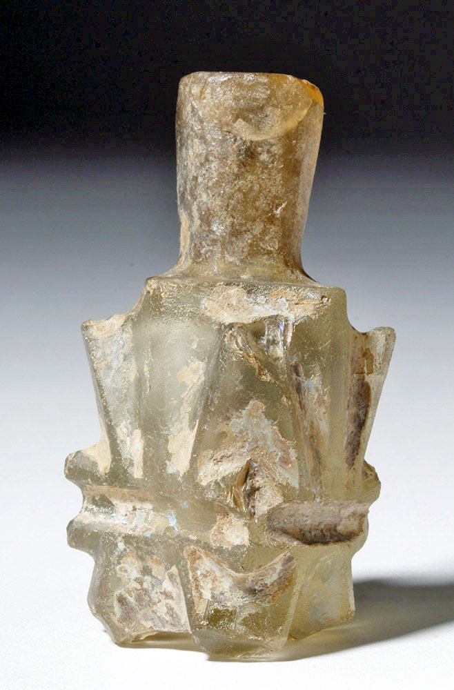 Fine Byzantine Islamic "Molar" Glass Flask: Byzantine/Islamic, ca. 8th to 9th century CE. This is a clear glass flask. Objects like this are called "molar" because their feet resemble the roots of those teeth. This bottle was made from a molded
