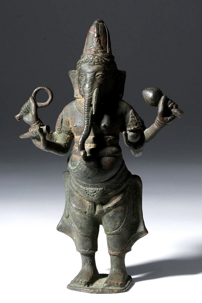 19th C. Indian Bronze Multi-arm Standing Ganesha: Central India, ca. 19th century CE. Heavy cast bronze statue of Ganesha (Ganesh) the 'bringer of good fortune', the elephant headed Hindu deity. He holds a seashell, a broken tusk, a ball of sweets, a
