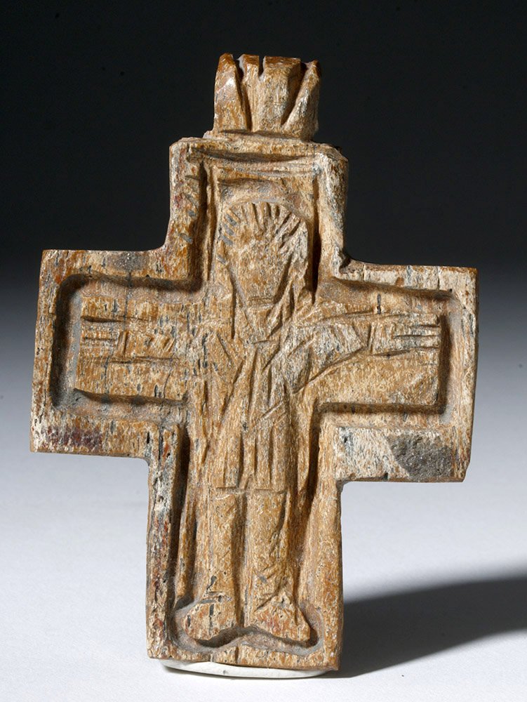 Rare Byzantine Bone Cross Pendant: Byzantine Empire, ca. 8th to 12th century CE. This is a very rare and desirable bone pendant in the form of a cross. The nearly symmetrical cross is carved with an image of Jesus in crucifixion pose, 