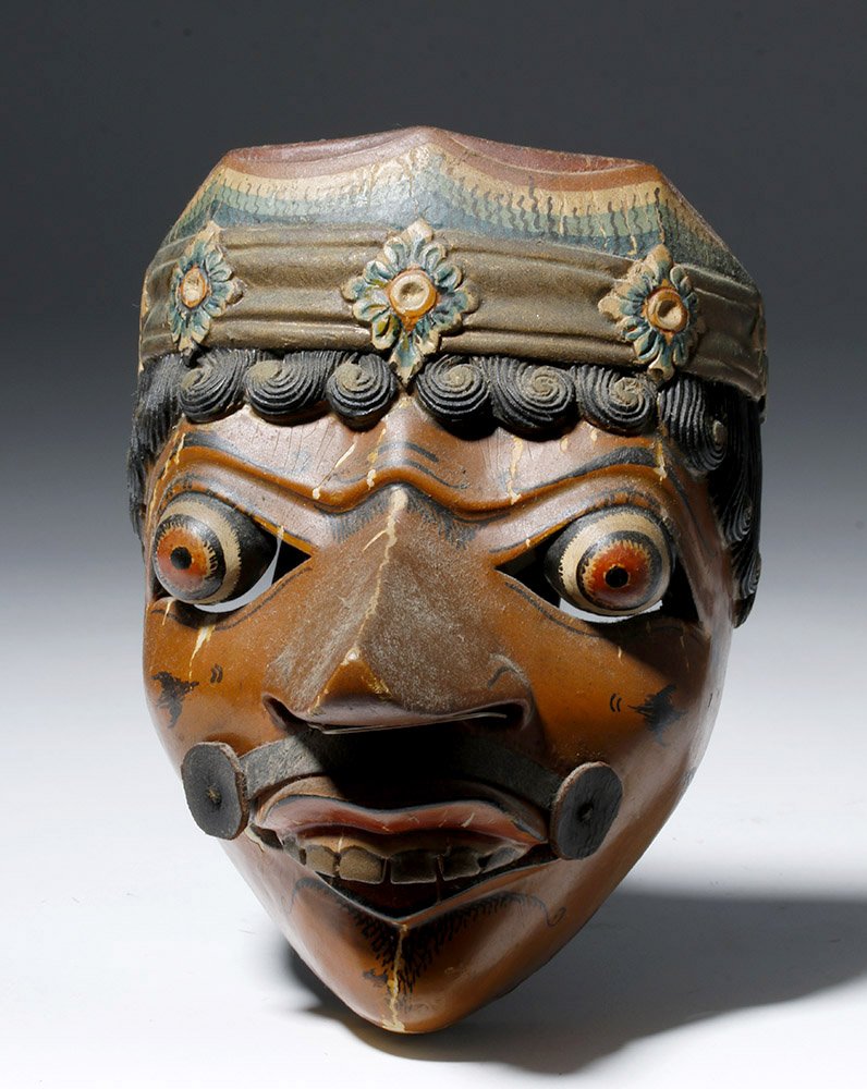 19th C. Indonesian Wood Klono Mask: ** A portion of the proceeds from the sale of this lot will benefit The Fowler Museum at UCLA ** Indonesia, Java, late 19th century. Brown klono face with bulging red eyes and protruding gold teeth. H