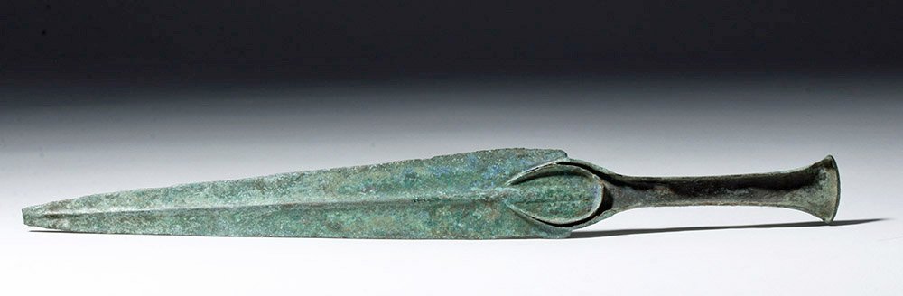 Very Fine Luristan Flanged Bronze Dagger: From the ancient near east, Luristan, ca. 1000 to 650 BCE. This is a flanged cast bronze dagger that at one time would have had a handle made of wood, stone, or bone. The crescent shape of the guard i