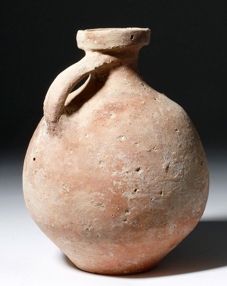 Holyland Pottery Jug - Time of King David, ca. 1000 BCE: Holy Land, Iron Age I, ca. 1200 to 1000 BCE. A bulbous earthenware jug with a small rounded handle from shoulder to spout and a flared rim. Historically, the Iron Age in the Holy Land was the time whe