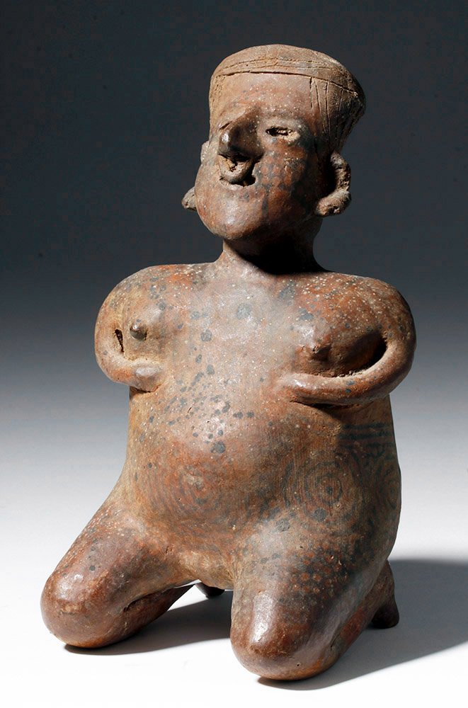 Nayarit Tattooed Kneeling Female, Birthing Pose: Pre-Columbian, West Mexico, Nayarit, San Sebastian type, ca. 300 BCE to 300 CE. Nude except for ear and nose ornaments, this female figure presents a kneeling posture with hands placed above her abdom