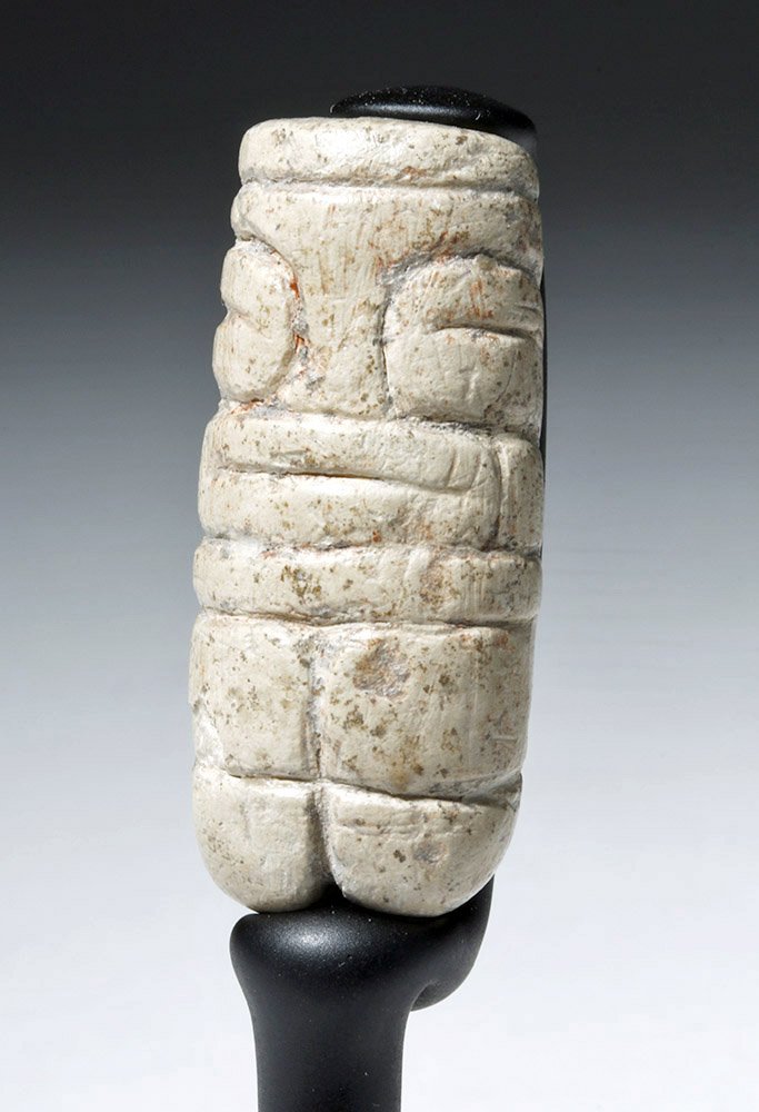 Rare & Fine Valdivian White Stone Venus Figure: Pre-Columbian, Ecuador, Valdivian culture, ca. 4000 to 3500 BCE. A small, cylindrical carved piece of creamy white and grey stone representational figure, highly polished, with an incised design that 
