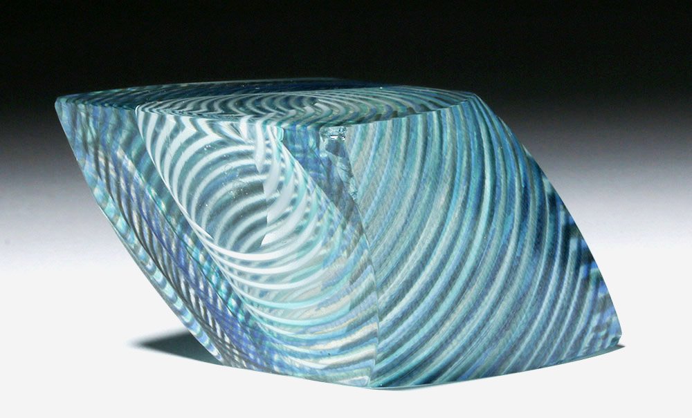 Gorgeous Correia Art Glass Paperweight, James Caswell: James Caswell Davis (American, 1930-2016), Correia Art Glass paperweight, 1988 CE. A stunning Correia art glass paperweight of a mesmerizing optical pattern in hues of cobalt blue, teal green, white, 