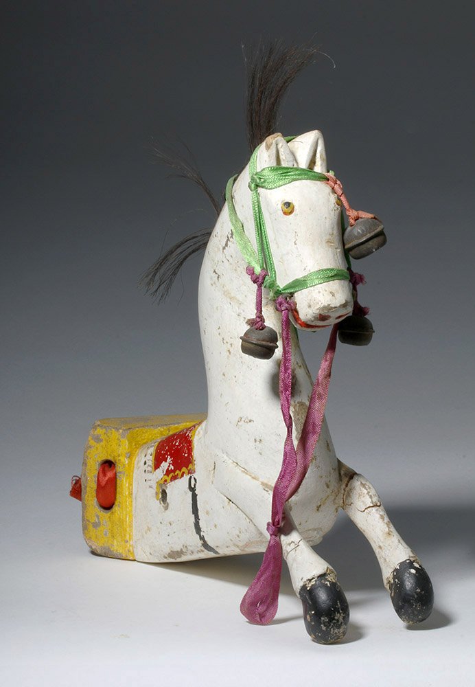 Antique Mexican Painted Wood Horse: ** A portion of the proceeds from the sale of this lot will benefit The Fowler Museum at UCLA ** Mexico, 19th to early 20th century CE. A brightly painted wooden horse, with cloth, bell, and real hors