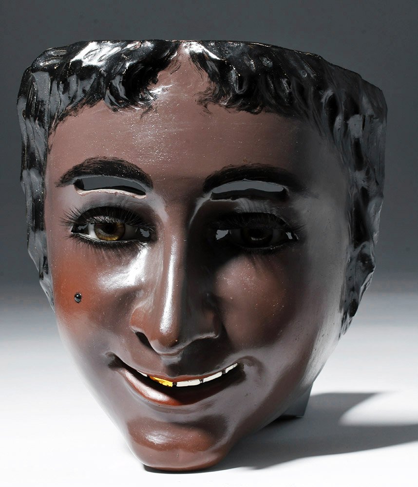 Rare Mexican Catrine Dandy Mask - Mechanical Eyes: Mexico, ca. 1950 CE. Superb Mexican Catrine "Dandy" mask. Painted carved wood with dark brown complexion, deep black hair, single gold tooth and glass eyes with mechanical eyelids controlled by a stri