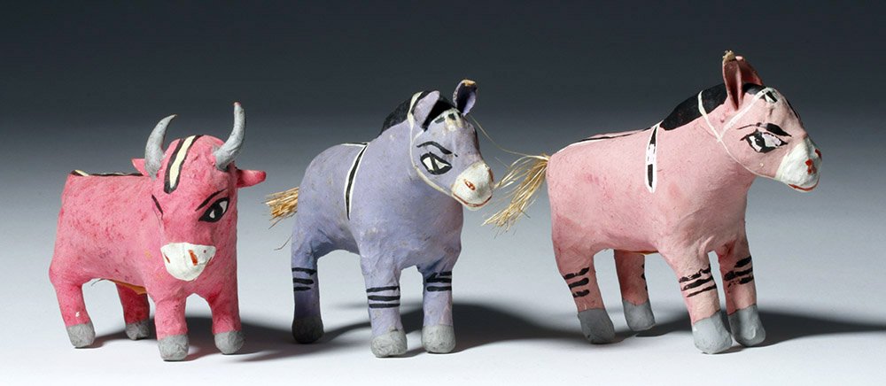 Trio of 20th C. Mexican Papier-Mache Burros and Goat: ** A portion of the proceeds from the sale of this lot will benefit The Fowler Museum at UCLA ** Mexico, Celaya, 20th century CE. This is a trio of matching papier mache animals: a dark pink goat with
