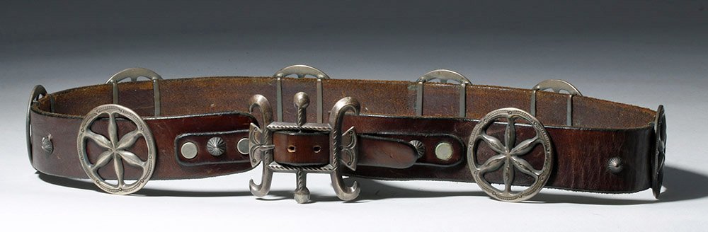 1920s Navajo Sandcast Silver Belt w/ Corn Design: ** A portion of the proceeds from the sale of this lot will benefit The Fowler Museum at UCLA ** Southwestern USA, Navajo people, ca. 1925 CE. A high-quality leather belt with silver appliques - inter