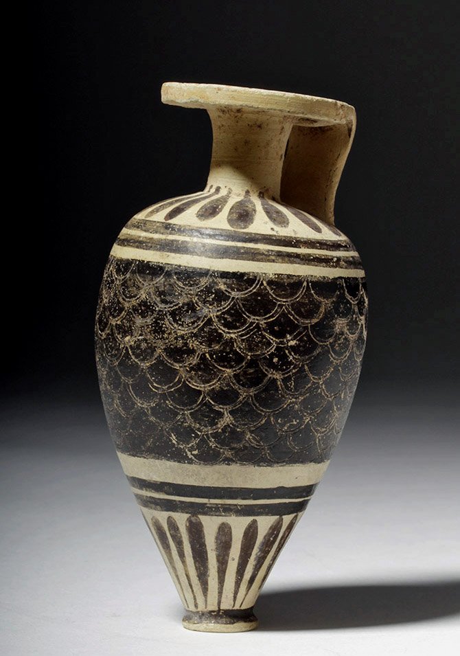 Etrusco-Corinthian Black-on-White Aryballos: Classical World, Italy, ca. 630 to 540 BCE. A miniature aryballos, painted black with a scale and linear banded decoration around its middle, and long, leaf-like shapes around the lower body, shoulder
