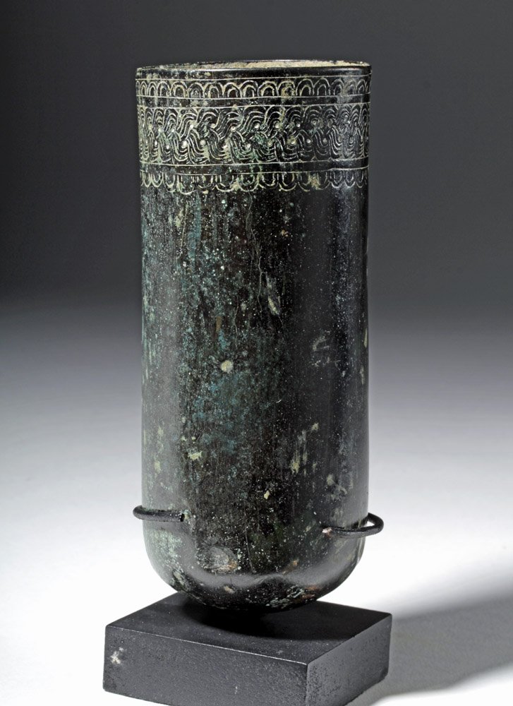Ancient Persian Achaemenid Incised Bronze Beaker: Ancient Near East, Achaemenid Persian Empire, ca. 550 to 330 BCE. A gorgeous cast bronze beaker with amazing incised design in a thick band around the rim that echoes a woven design. The base is curve