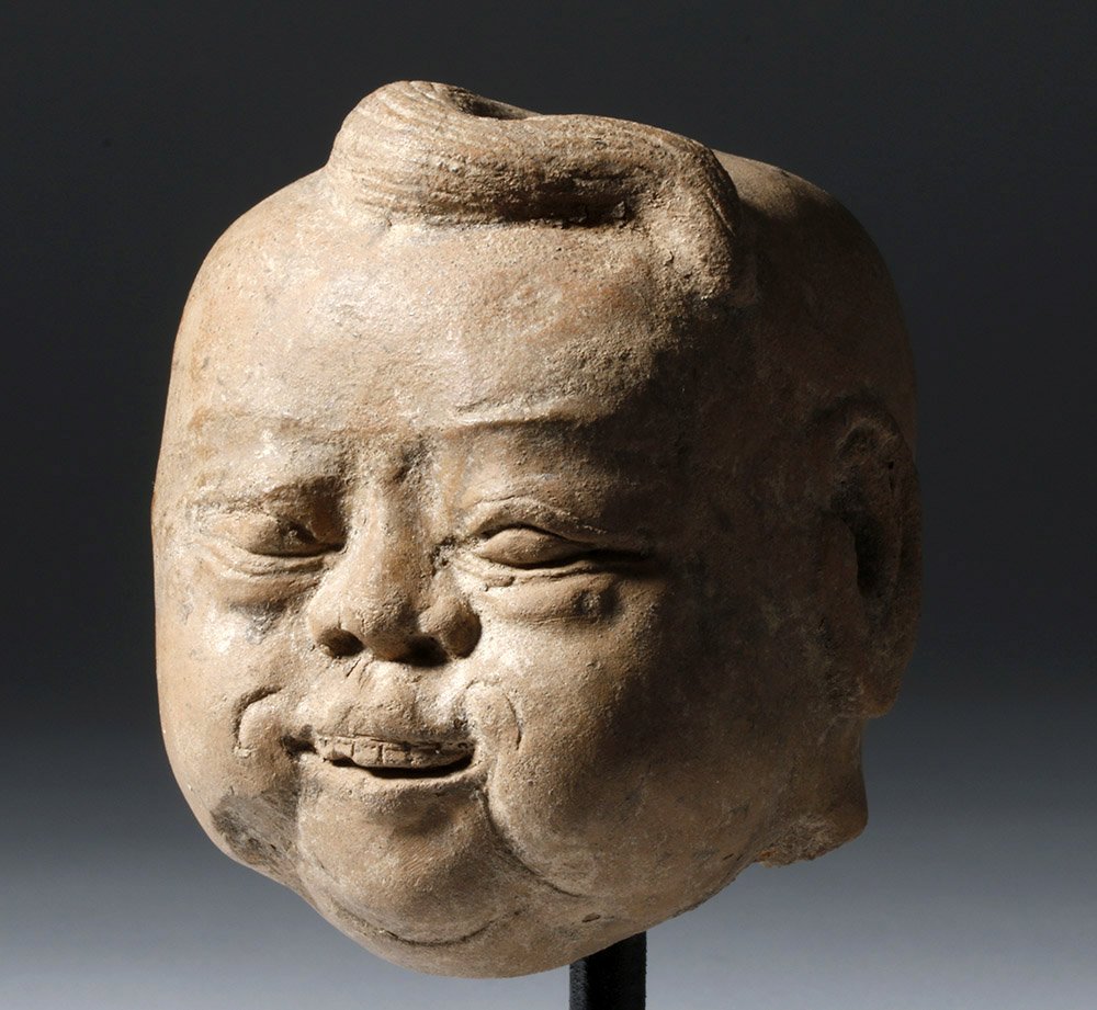 Superb Chinese Yuan Dynasty Head of a Lohan ex-Arnovick: China, Yuan Dynasty, 1279 to 1368 CE. The Yuan Dynasty came about from the conquest of the Song Dynasty by the great Mongolian ruler Kublai Khan. This fascinating pottery head from this time of Kublai