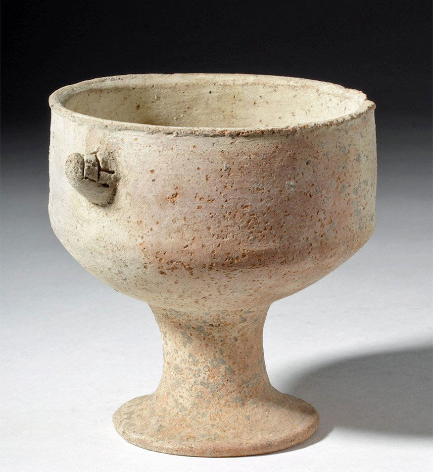 Holy Land Iron Age Pottery Chalice: Holy Land, Iron Age, ca. 8th to 5th century BCE. A buff redware chalice, wheel made, with small handles with incised designs on either side. Size: 5.4" W x 4.3" H (13.7 cm x 10.9 cm) Provenance: Ex-P