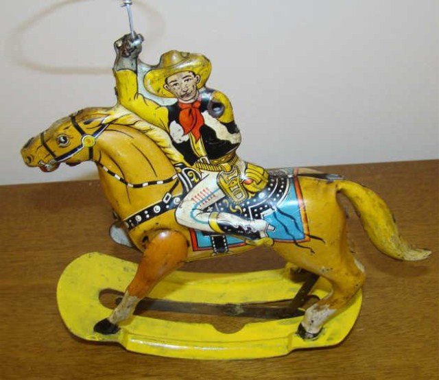 Tin Litho Cowboy: riding a horse Condition vg/g