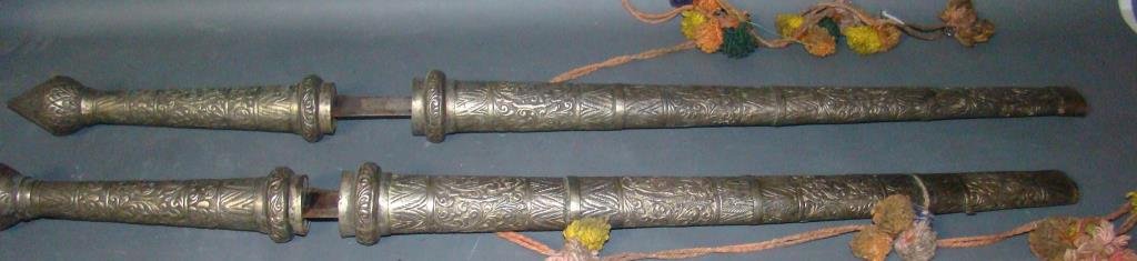 Lot of 2 Antique Thai Military Swords: repoussé silver Thai swords and scabbards; with battle scenes on blades 38" Condition vg/g
