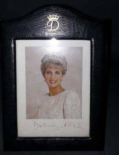 Signed Autograph of Princess Diana: signed photo from Buckingham Place; house in original black leather frame with a gold embossed crest D and crown 7.75" x 5.25" Condition vg/g