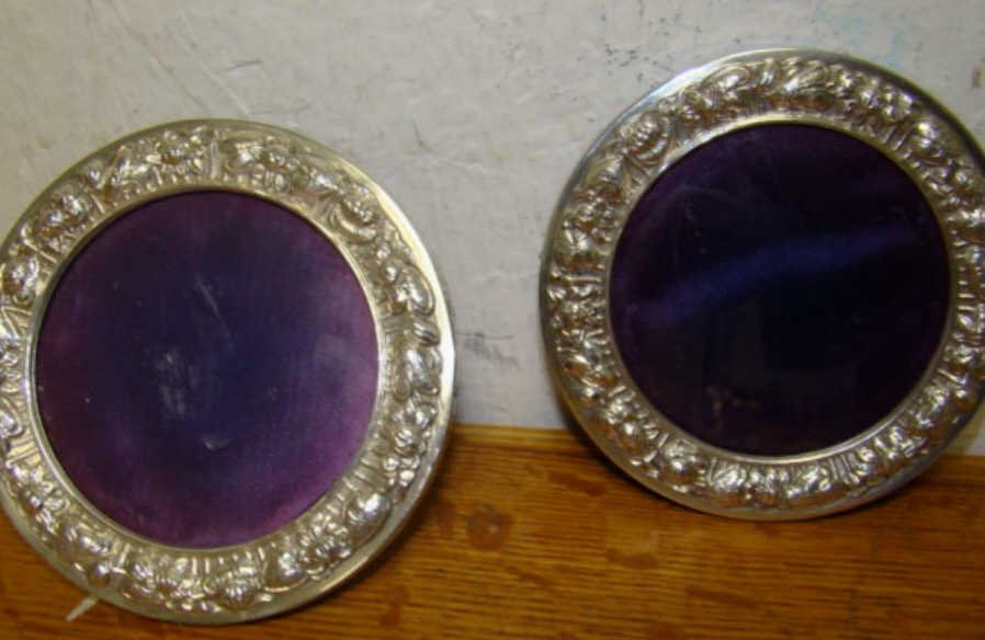 Pair of 2 Repousse Sterling Frames: round ornate Condition one frame is missing stand