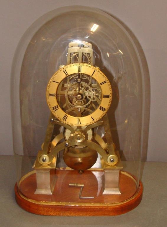 Brass Skeleton Mantle Clock on Pedestal Base: under glass dome display case, clock measures 12.5" h x 7" w, case measures 15.5" h x 9" w