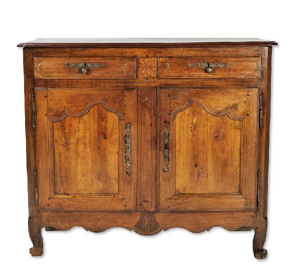 A LOUIS XV FRENCH PROVINCIAL BUFFET, France, Mid-Ei: A LOUIS XV FRENCH PROVINCIAL BUFFET France, Mid-Eighteenth Century The rectangular top with chamfered front corners and molded edge above two drawers, each with two brass knobs below decorative scroll