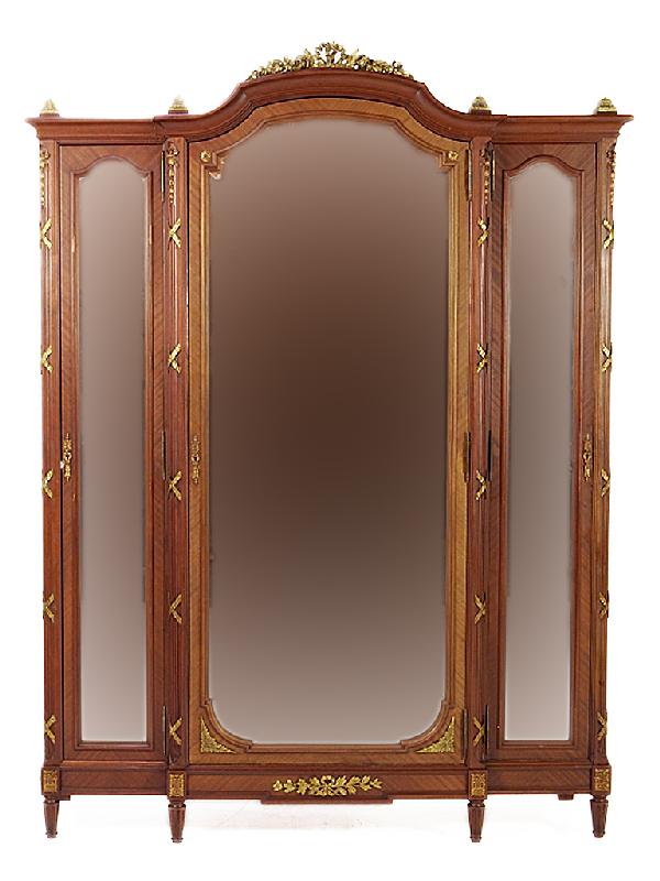 A LOUIS XVI WALNUT ARMOIRE France Nineteenth Centu: A LOUIS XVI WALNUT ARMOIRE France Nineteenth Century triple door, beveled mirror and ormolu detail 93 x 71 x 20 inches