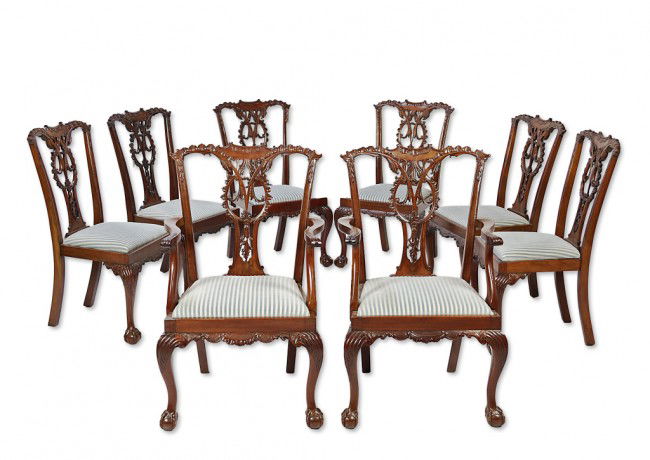 A FINELY CARVED SET OF EIGHT CHIPPENDALE STYLE MAHO: A FINELY CARVED SET OF EIGHT CHIPPENDALE STYLE MAHOGANY DINING CHAIRS Circa 1870 Including two armchairs and six side chairs, each with pierced splats with rocaille carving, ball-and-claw feet, and he