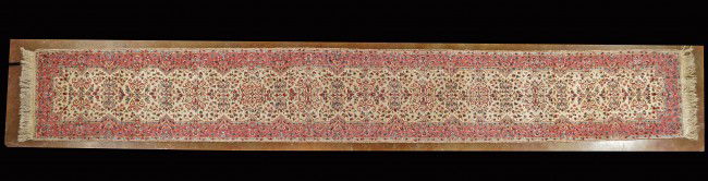 A PERSIAN KERMAN RUG: A PERSIAN KERMAN RUG 2 ft 7 in x 18 ft 9 in