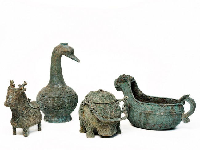 A COLLECTION OF FOUR OXIDIZED ASIAN CONTAINERS: A COLLECTION OF FOUR OXIDIZED ASIAN CONTAINERS tallest measuring 12 x 6 1/2 x 6 1/2 inches
