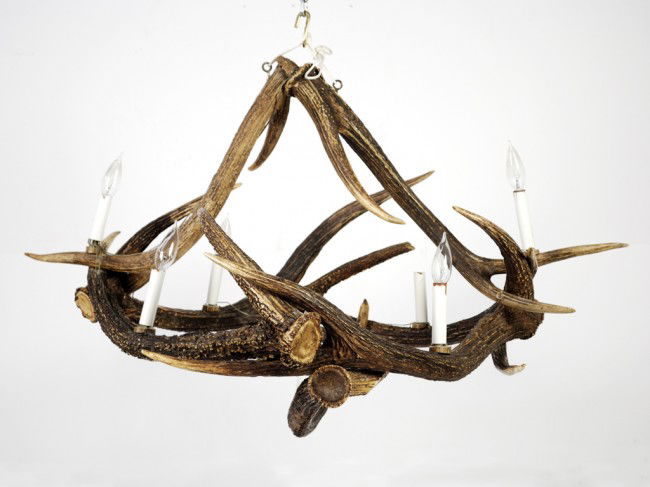 A SEVEN LIGHT STAGHORN CHANDELIER German: A SEVEN LIGHT STAGHORN CHANDELIER German with candle form light fixtures 24 x 41 x 31 inches