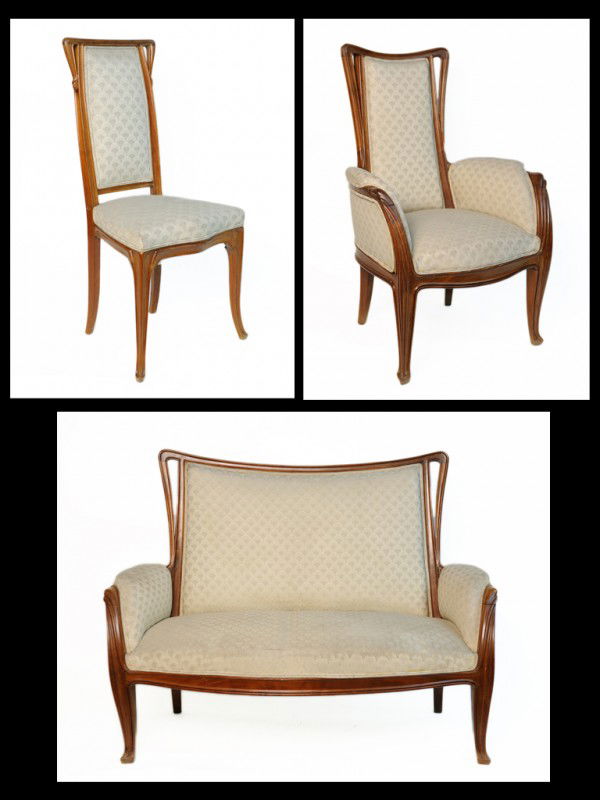 A SET OF ART NOUVEAU FOUGÈRES PARLOR SEATING Attri: A SET OF ART NOUVEAU FOUGÈRES PARLOR SEATING Attributed to Louis Majorelle, Nancy, France Including an Art Nouveau settee (canapé), a bergère chair and side chair, all of sculpted wood. Settee: 54