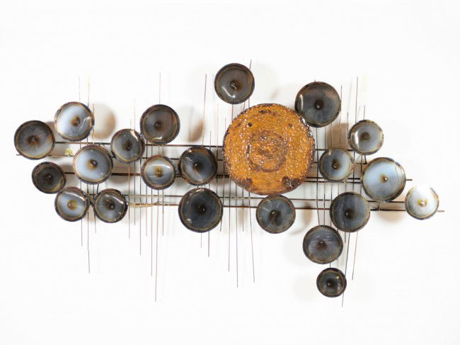 A VINTAGE METAL WALL SCULPTURE In the style of Cur: A VINTAGE METAL WALL SCULPTURE In the style of Curtis Jere The wall sculpture in the "Raindrops" motif made popular by Curtis Jere, of brass and metal discs mounted. 24 x 42 1/2 inches