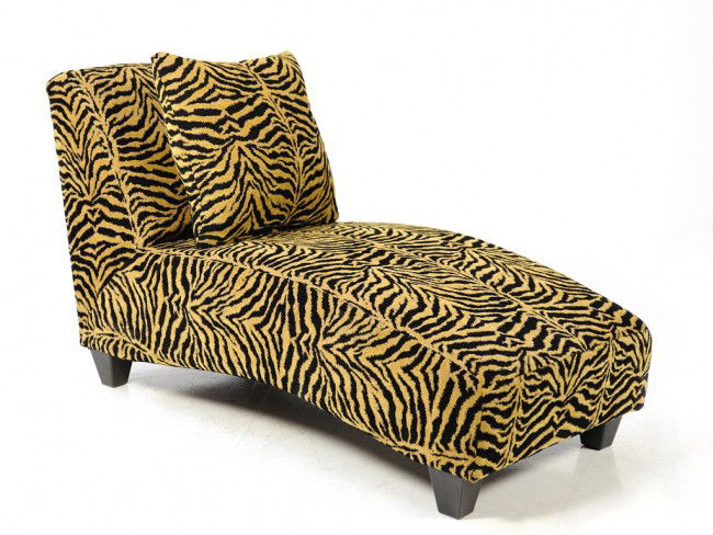 A CHAISE LOUNGE IN TIGER STRIPED FABRIC UPHOLSTERY: A CHAISE LOUNGE IN TIGER STRIPED FABRIC UPHOLSTERY WITH ACCENT PILLOW 35 1/2 x 59 x 29 inches