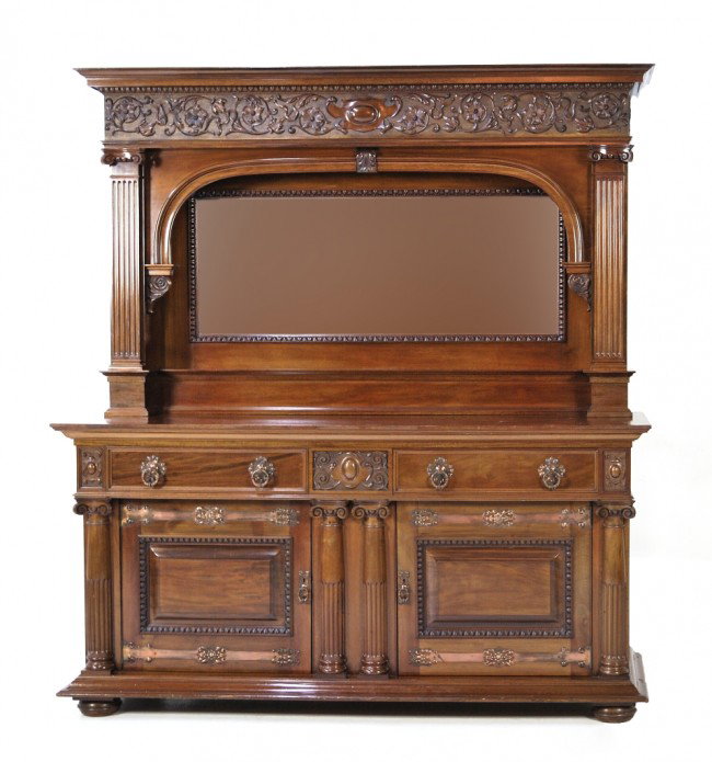 AN ARCHITECTURAL MAHOGANY BUFFET, American, Twenti: AN ARCHITECTURAL MAHOGANY BUFFET American, Twentieth Century The cornice level with egg-and-dart border above the frieze with central cartouche and scrolling foliage with ribbons, all on a tooled back