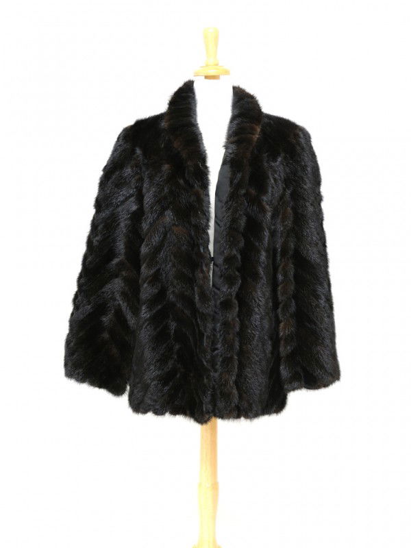 A RICH DARK BROWN MINK COAT: A RICH DARK BROWN MINK COAT waist length with ribbed chevron design, metal hook and eye closure, two side pockets Approximately size 10