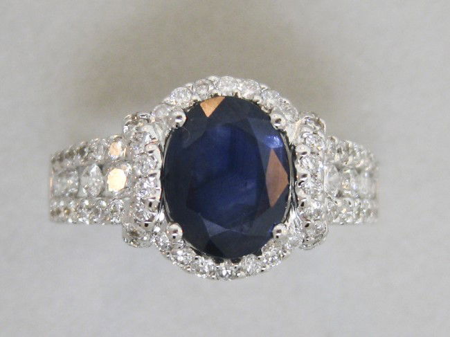 LADIES 14K WHITE GOLD DIAMOND AND SAPPHIRE RING: LADIES 14K WHITE GOLD DIAMOND AND SAPPHIRE RING Finger Size 6 1/2. set with one oval blue sapphire=2.81 Ct., 66 round full cut diamonds=.71 CT., Color Grade-G, Clarity Grade-SI1.