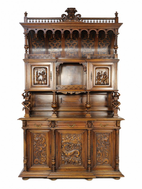 A HENRY II RED WALNUT RENAISSANCE REVIVAL INSPIRED: A HENRY II RED WALNUT RENAISSANCE REVIVAL INSPIRED BUFFET France, Late 19th Century carved North wind mask pediment, gothic relief carved curved back etegere pierced gallery; the etegere superstructur