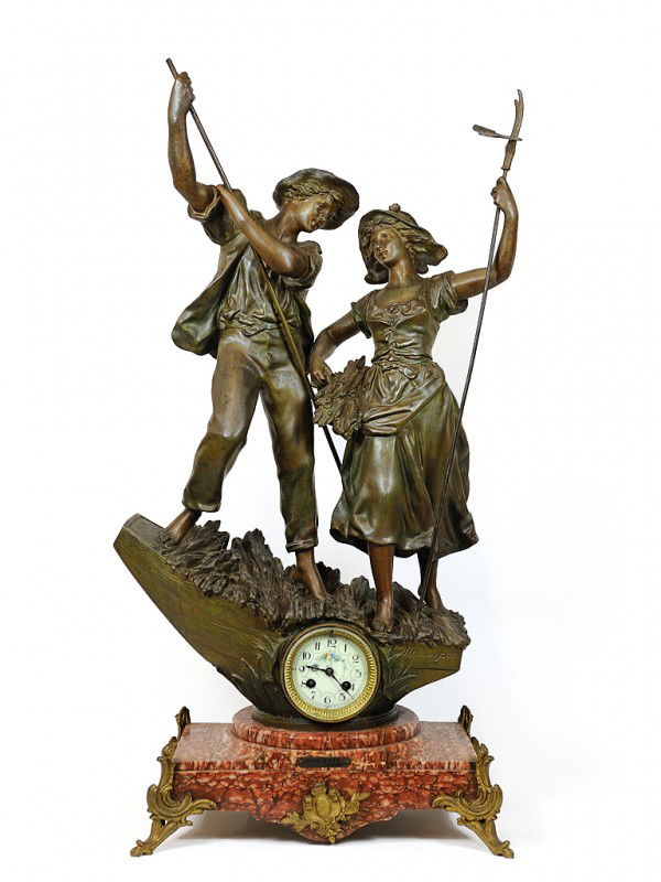 A FRENCH FIGURAL BRONZE MANTEL CLOCK France: A FRENCH FIGURAL BRONZE MANTEL CLOCK France, Nineteenth Century The statue of a young peasant couple in full detail surmouting the base with clock of porcelain dial; on a red marble stand with brass f