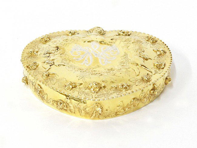 A FINE TIFFANY & COMPANY GILDED STERLING BOX: A FINE TIFFANY & COMPANY GILDED STERLING HEART-SHAPED BOX Tiffany and Co., New York, NY, First Quarter Twentieth Century The Art Nouveau gilded sterling heart-shaped lidded box having an elaborate han