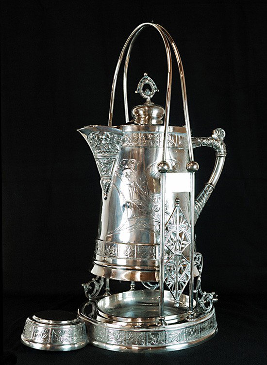 A QUADRUPLE SILVER PLATED TILTING ICE-WATER PITCHER: A QUADRUPLE SILVER PLATED TILTING ICE-WATER PITCHER AND STAND, Late-Nineteenth Century Mark of Pairpoint Manufacturing Company, founded 1880, New Bedford, Massachusetts Consisting of a swinging pitche