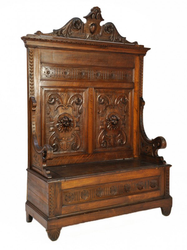 AN ITALIAN RENAISSANCE REVIVAL HALL SETTEE, Italy: AN ITALIAN RENAISSANCE REVIVAL HALL SETTEE Italy, Circa 1880 The antique settee of carved walnut with hinged seat for storage, detailed with lion mask carving. 89 inches height x 52 inches length x 21