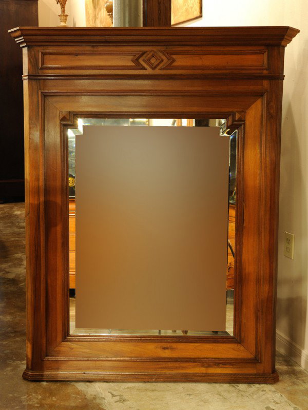 A HENRY II STYLE WALNUT BEVELED PIER MIRROR; Circa : A HENRY II STYLE WALNUT BEVELED PIER MIRROR; Circa 1940 having moulded stepped cornice and plinth 56 x 42 1/2 x 4 inches