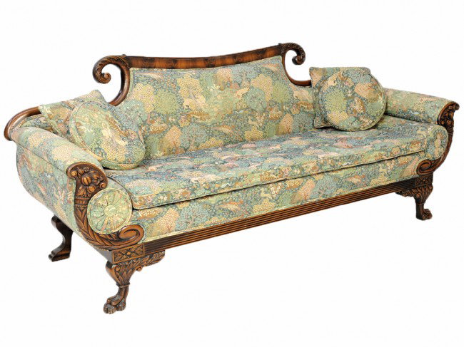 AN ANTIQUE AMERICAN EMPIRE STYLE SOFA: AN ANTIQUE AMERICAN EMPIRE STYLE SOFA with tapestry upholstery, scrolling foliate accents, rolled arms, relief carved cornucopia to arm terminals, reeded apron, accent pillows, on paw feet 35 3/4 x 85