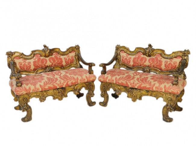 A PAIR OF ITALIAN BAROQUE "GROTTO" SETTEES, Italy,: A PAIR OF ITALIAN BAROQUE "GROTTO" SETTEES, Italy, Nineteenth Century fully carved in the round exposed giltwood frame with Fortuny upholstered seat and back, the scale carved undulating crestrail is