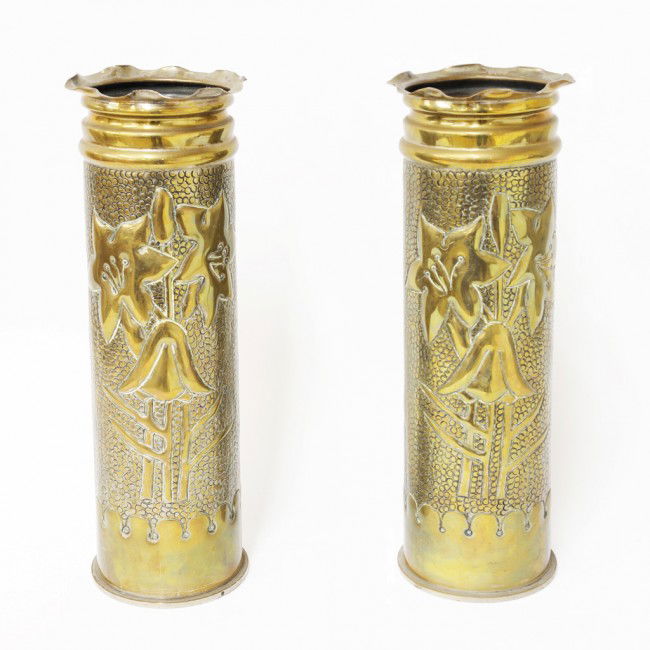 A PAIR OF ARTILLERY SHELLS 1913: A PAIR OF ARTILLERY SHELLS 1913 made into vases with embossed lilies 15 1/4 x 5 x 5 inches