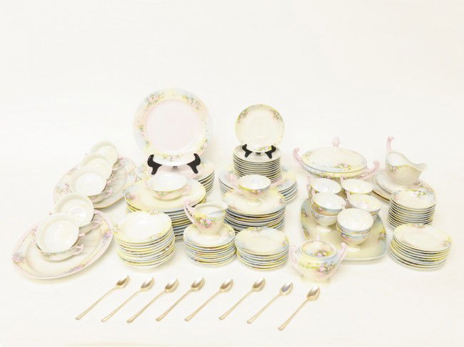 A CZECHOSLOVAKIAN PORCELAIN DINNER SERVICE WITH EIGH: A CZECHOSLOVAKIAN PORCELAIN DINNER SERVICE WITH EIGHT STERLING ICE TEASPOONS; Twentieth Century the Royal Epiag signed floral decorated porcelain on pastel ground and opalescent interiors. 124 pieces