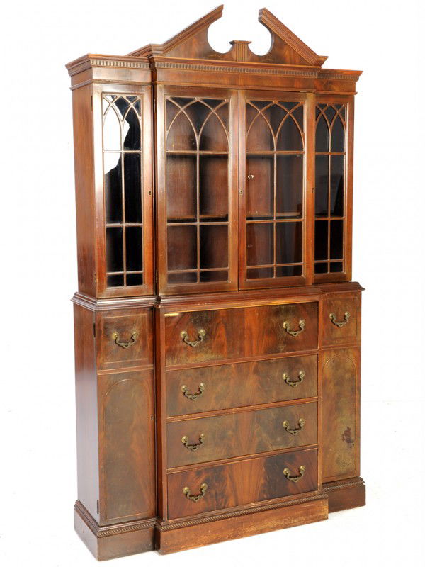 A MAHOGANY BREAK FRONT CABINET: A MAHOGANY BREAK FRONT CABINET with arched glass panes 80 x 47 1/2 x 14 inches