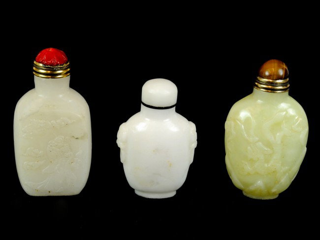 THREE JADE SNUFF BOTTLES: THREE JADE SNUFF BOTTLES one with tiger eye cap, one with red coral cap 3 x 1 1/2 x 1 inches (larges)