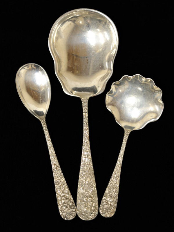 A TRIO OF STEIFF STERLING "FLORAL REPOUSSE" SERVIN: A TRIO OF STEIFF STERLING "FLORAL REPOUSSE" SERVING SPOONS USA, Circa 1892-1925 including one 6" sugar spoon, one large 7 7/8" ice spoon having an elongated scalloped bowl with mono on verso; one 5 1/