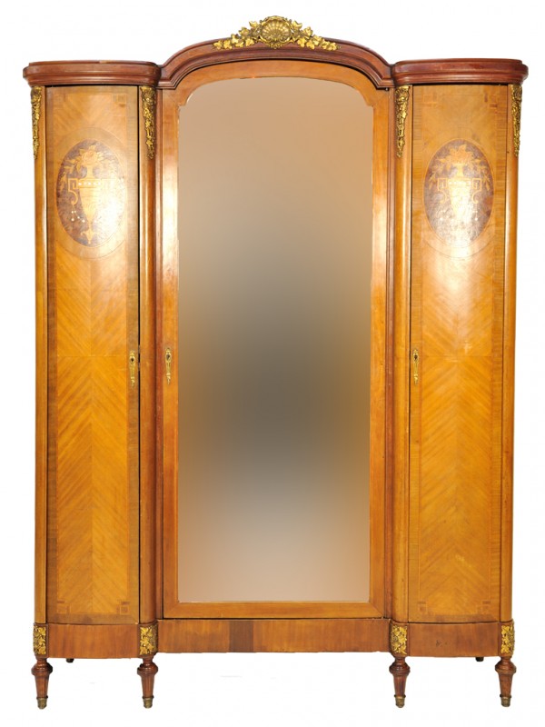 A LOUIS XV WALNUT TRIPLE DOOR ARMOIRE: A LOUIS XV WALNUT TRIPLE DOOR ARMOIRE with mother of pearl inlay and marquetry work details; ormolu mounts with shell and ivy crest mount; an arched beveled mirror 94 x 66 x 20 inches