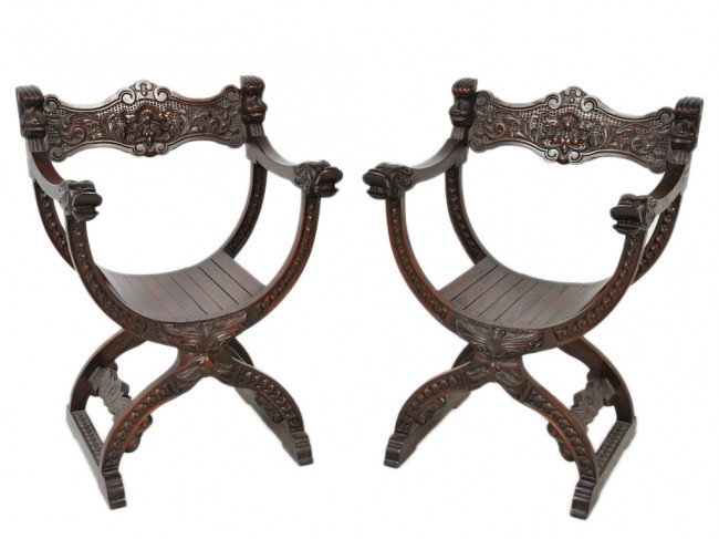 A PAIR OF MAHOGANY CARVED DANTESCA CHAIRS, Possibl: A PAIR OF MAHOGANY CARVED DANTESCA CHAIRS, Possibly Flemish with Man of the North detail to X joint, high relief carved dragon arm terminals, with cross stippling and feline carved back splat, with sc
