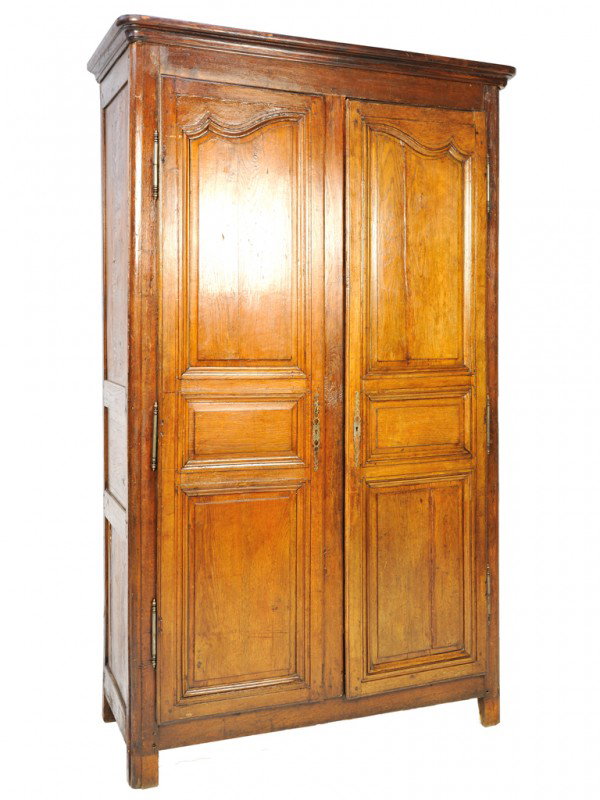 A COUNTRY FRENCH OAK ARMOIRE WITH INSET BEVELED PA: A COUNTRY FRENCH OAK ARMOIRE WITH INSET BEVELED PANELS 18th Century with two doors, hammered and pierced brass mounts 89 x 56 x 23 inches
